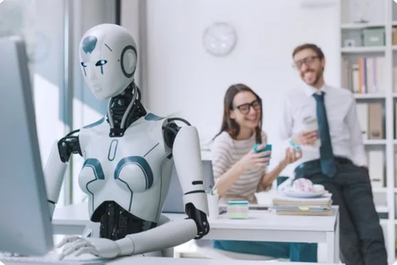 A humanoid robot working at a desk in an office